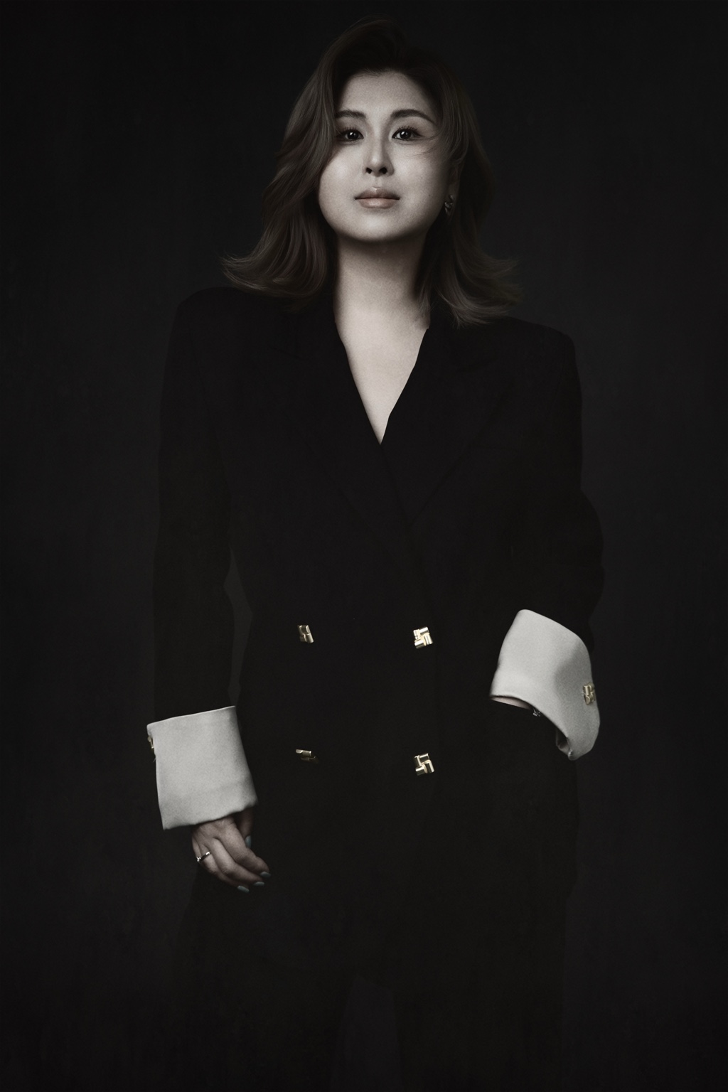 Nikki Kong, founder of VIVÉ CIRCLE, in a black tailored outfit